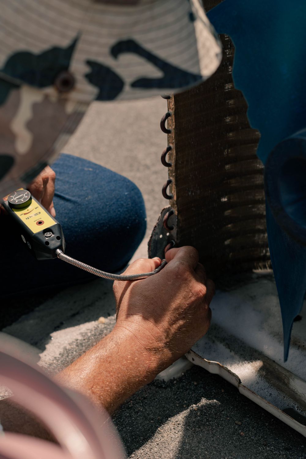 Technician servicing an AC condenser coil